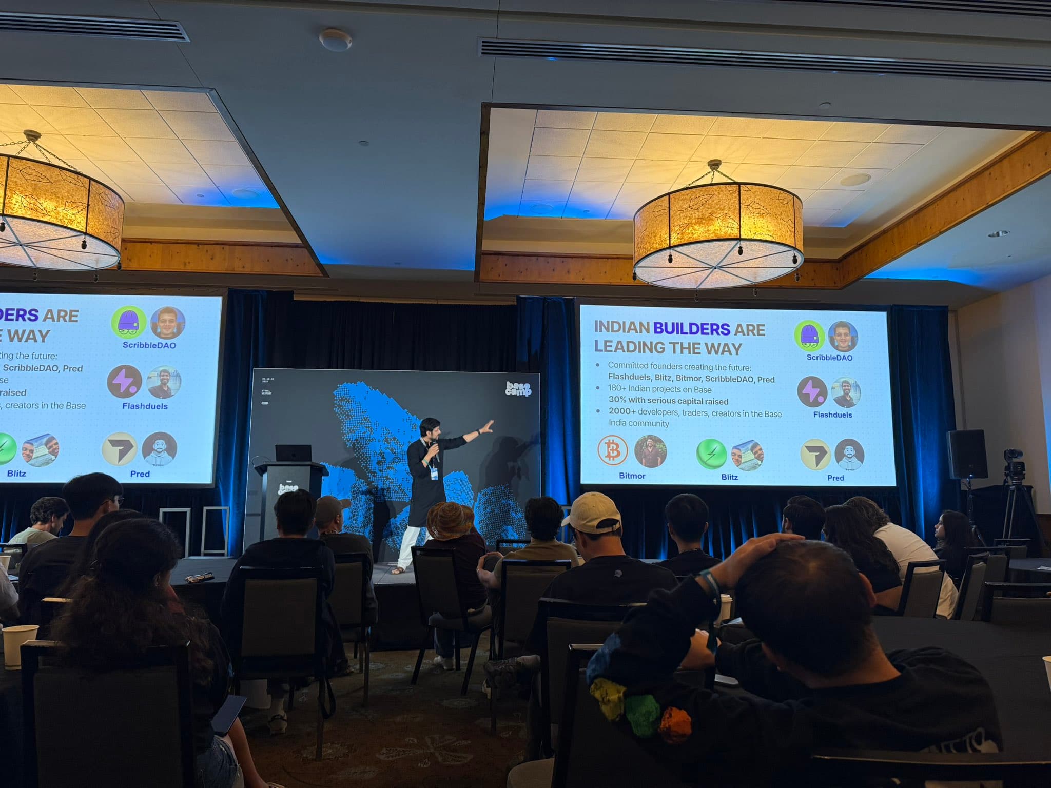 Delivering a talk on stage at BaseCamp 2025, slides reading 'Indian builders are leading the way'